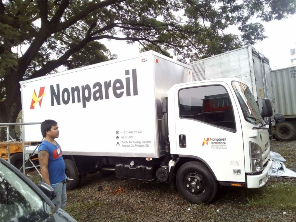 Nonpareil International delivery truck with acrylic signage in Mandaluyong, featuring logo and contact info by M&G Global Ads.